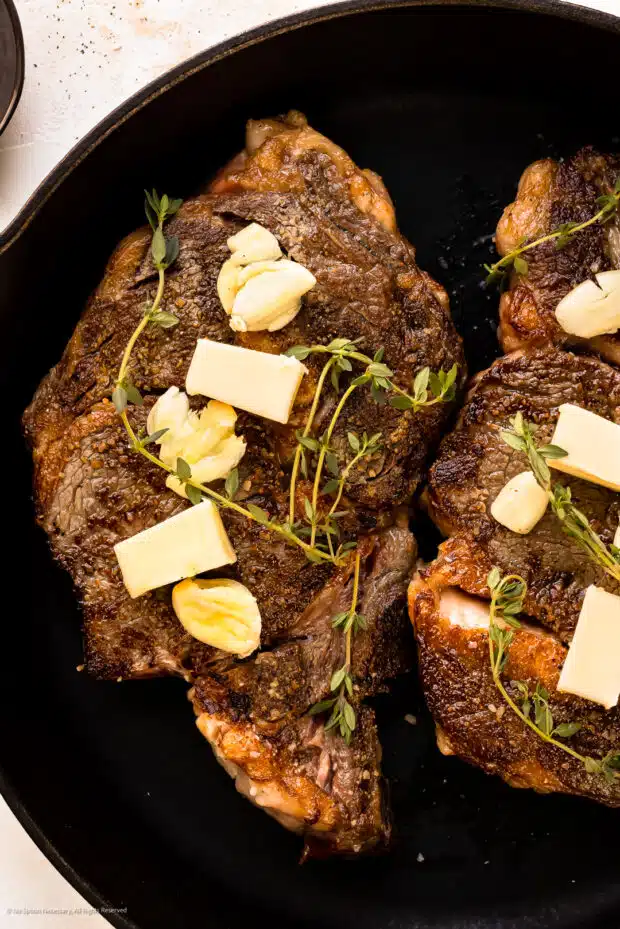 Grilled Rib Eye Steak with Roasted Garlic Resting Butter - Hey
